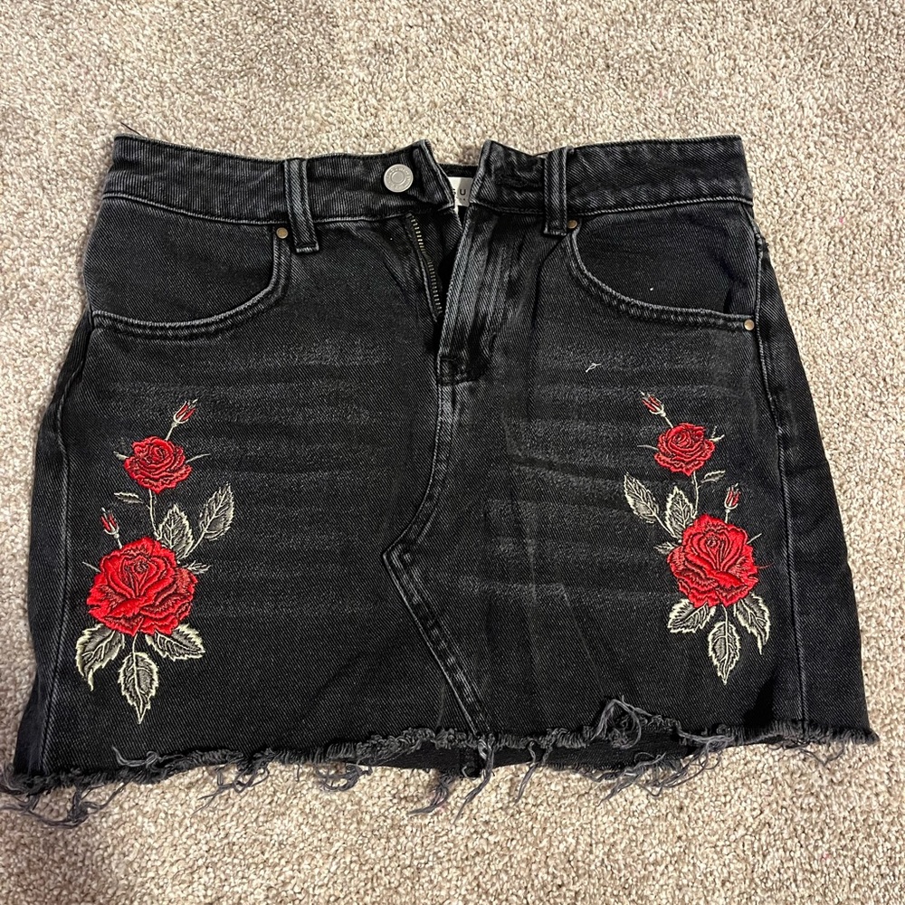 short black skirt with rose details on the bottom